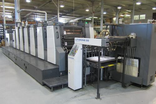 A large machine in a warehouse with many machines.